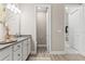 Bathroom with a sink, quartz countertop, white cabinets, tiled floors, and an adjacent toilet room at 2236 Oconnel Dr, Ormond Beach, FL 32174