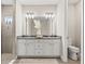 Bathroom featuring double sinks, quartz countertop, white cabinets, large mirrors and modern fixtures at 2236 Oconnel Dr, Ormond Beach, FL 32174