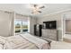 Bright bedroom with a ceiling fan, plush carpet, dresser, and large window with a view of the outdoors at 2236 Oconnel Dr, Ormond Beach, FL 32174
