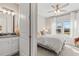 Inviting bedroom has a vanity and plush bedding with natural light from large windows at 2236 Oconnel Dr, Ormond Beach, FL 32174