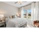 Airy bedroom has a plush bed, side tables, and a window view for natural lighting at 2236 Oconnel Dr, Ormond Beach, FL 32174