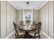 Cozy dining room with elegant wood table, chairs, wainscotting, and pendant lighting at 2236 Oconnel Dr, Ormond Beach, FL 32174