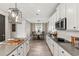 Open kitchen featuring white cabinets, modern lighting, and stainless steel appliances at 2236 Oconnel Dr, Ormond Beach, FL 32174