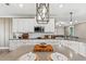 Stylish kitchen featuring white cabinets, modern lighting, and open layout design at 2236 Oconnel Dr, Ormond Beach, FL 32174