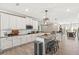 Bright kitchen with white cabinets, modern lighting, and stainless steel appliances at 2236 Oconnel Dr, Ormond Beach, FL 32174