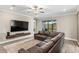 Comfortable living room with a large sectional sofa, ceiling fan, and views of the outdoor patio at 2236 Oconnel Dr, Ormond Beach, FL 32174