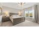 Serene main bedroom with a large bed, neutral tones, ceiling fan, and natural light from windows at 2236 Oconnel Dr, Ormond Beach, FL 32174