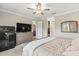 Main bedroom with a dresser, ceiling fan, walk-in closet, and ensuite bathroom at 2236 Oconnel Dr, Ormond Beach, FL 32174