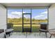 Screened-in patio with water view, comfortable seating, and outdoor living space at 2236 Oconnel Dr, Ormond Beach, FL 32174