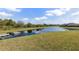 Scenic view of a tranquil pond with a dock, enhancing the property's appeal at 2236 Oconnel Dr, Ormond Beach, FL 32174
