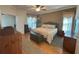 Cozy bedroom featuring a comfortable bed, soft carpeting, and natural light streaming through the window at 2327 Addison Ave, Clermont, FL 34711
