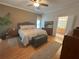 Comfortable bedroom featuring a ceiling fan, stylish furnishings, and an ensuite bathroom at 2327 Addison Ave, Clermont, FL 34711
