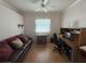 Simple office/bedroom with a wood desk, comfortable sofa, and a ceiling fan at 2327 Addison Ave, Clermont, FL 34711