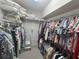 Walk-in closet with lots of storage space and hanging rods at 2327 Addison Ave, Clermont, FL 34711