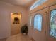 Bright entryway with decorative glass door and sidelights, a plant and niche for displaying decor at 2327 Addison Ave, Clermont, FL 34711