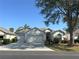 Charming home with a three car garage, mature landscaping, and a well-manicured lawn at 2327 Addison Ave, Clermont, FL 34711
