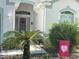 The front door is trimmed in matching green and is accessed by a concrete path at 2327 Addison Ave, Clermont, FL 34711