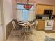 Eat-in kitchen with a round table and four chairs and white appliances at 2327 Addison Ave, Clermont, FL 34711