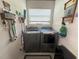 Clean laundry room equipped with a side-by-side washer and dryer set at 2327 Addison Ave, Clermont, FL 34711