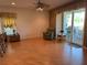 Bright living room featuring sliding glass doors with a view of the outdoors, hardwood flooring, and cozy seating at 2327 Addison Ave, Clermont, FL 34711