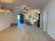 Spacious living room featuring neutral carpet and a ceiling fan at 2327 Addison Ave, Clermont, FL 34711