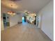Bright living room with neutral carpet, ceiling fan and kitchen view at 2327 Addison Ave, Clermont, FL 34711