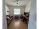 Well-lit office space with a wooden desk, comfortable sofa, and laminate floors at 2327 Addison Ave, Clermont, FL 34711