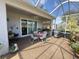 Covered patio area featuring outdoor seating and a barbecue grill for outdoor cooking at 2327 Addison Ave, Clermont, FL 34711