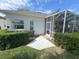 A screened lanai is accessed from the yard via a stepping stone sidewalk at 2327 Addison Ave, Clermont, FL 34711