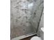 Modern bathroom shower features decorative stone flooring and a built-in toiletry shelf at 266 N High St, Lake Helen, FL 32744