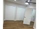 Cozy bedroom featuring closets, modern ceiling fan and wood-look flooring at 266 N High St, Lake Helen, FL 32744