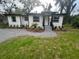 Charming single-story home with modern design, gravel landscaping and inviting front entrance at 266 N High St, Lake Helen, FL 32744