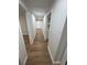 Hallway with wood-look flooring and white trim at 266 N High St, Lake Helen, FL 32744
