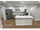 Bright kitchen with stainless steel appliances and a center island at 266 N High St, Lake Helen, FL 32744