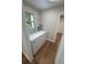 Bright laundry room with a window, wood-look flooring, and a side-by-side washer and dryer at 266 N High St, Lake Helen, FL 32744