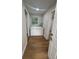 Bright laundry room with a window, wood-look flooring, and a side-by-side washer and dryer at 266 N High St, Lake Helen, FL 32744