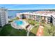 Stunning aerial view of the complex highlighting pool, lush landscaping and serene waterfront location at 2711 N Halifax Ave # 890, Daytona Beach, FL 32118
