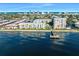 Aerial view of a waterfront residential complex featuring well-maintained landscaping, a pool, and private docks at 2711 N Halifax Ave # 890, Daytona Beach, FL 32118