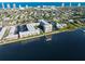 Expansive aerial view of waterfront condos with private boat dock, city skyline and ocean in the background at 2711 N Halifax Ave # 890, Daytona Beach, FL 32118