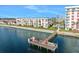 Exterior view of the building near a pier with lush landscaping and waterfront access at 2711 N Halifax Ave # 890, Daytona Beach, FL 32118