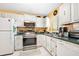 Cozy kitchen featuring white cabinets, stainless steel appliances and tiled floors at 2711 N Halifax Ave # 890, Daytona Beach, FL 32118