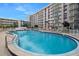 Community pool with lounge chairs and well-maintained landscaping, offering a relaxing outdoor amenity for residents at 2711 N Halifax Ave # 890, Daytona Beach, FL 32118