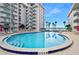 Inviting community pool area with lounge chairs and lush landscaping, perfect for outdoor relaxation and socializing at 2711 N Halifax Ave # 890, Daytona Beach, FL 32118