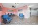 Comfortable sitting area with wicker chairs and coastal artwork near the elevators at 2711 N Halifax Ave # 890, Daytona Beach, FL 32118