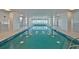 Bright indoor pool area with blue tiled pool, ocean views, and recessed lighting at 2967 S Atlantic Ave # 1203, Daytona Beach Shores, FL 32118