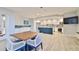 Resident kitchen with updated appliances, white cabinetry, large center island, and seating space at 2967 S Atlantic Ave # 1203, Daytona Beach Shores, FL 32118