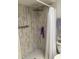 Modern shower features tile walls, rainfall shower head, and a stylish white shower curtain at 301 Paradise Ln, Edgewater, FL 32132