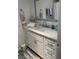 Stylish bathroom vanity features white cabinets, marble countertops, and modern fixtures at 301 Paradise Ln, Edgewater, FL 32132