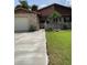 Charming single-Gathering home features brick accents, attached garage, and manicured front lawn at 301 Paradise Ln, Edgewater, FL 32132