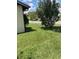 Well-maintained lawn and mature tree in front yard, enhancing curb appeal at 301 Paradise Ln, Edgewater, FL 32132